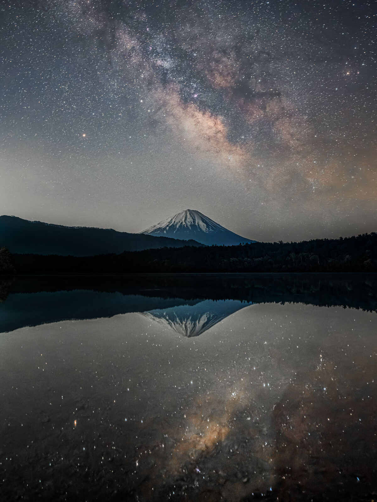 A mountain silhouette over calm water